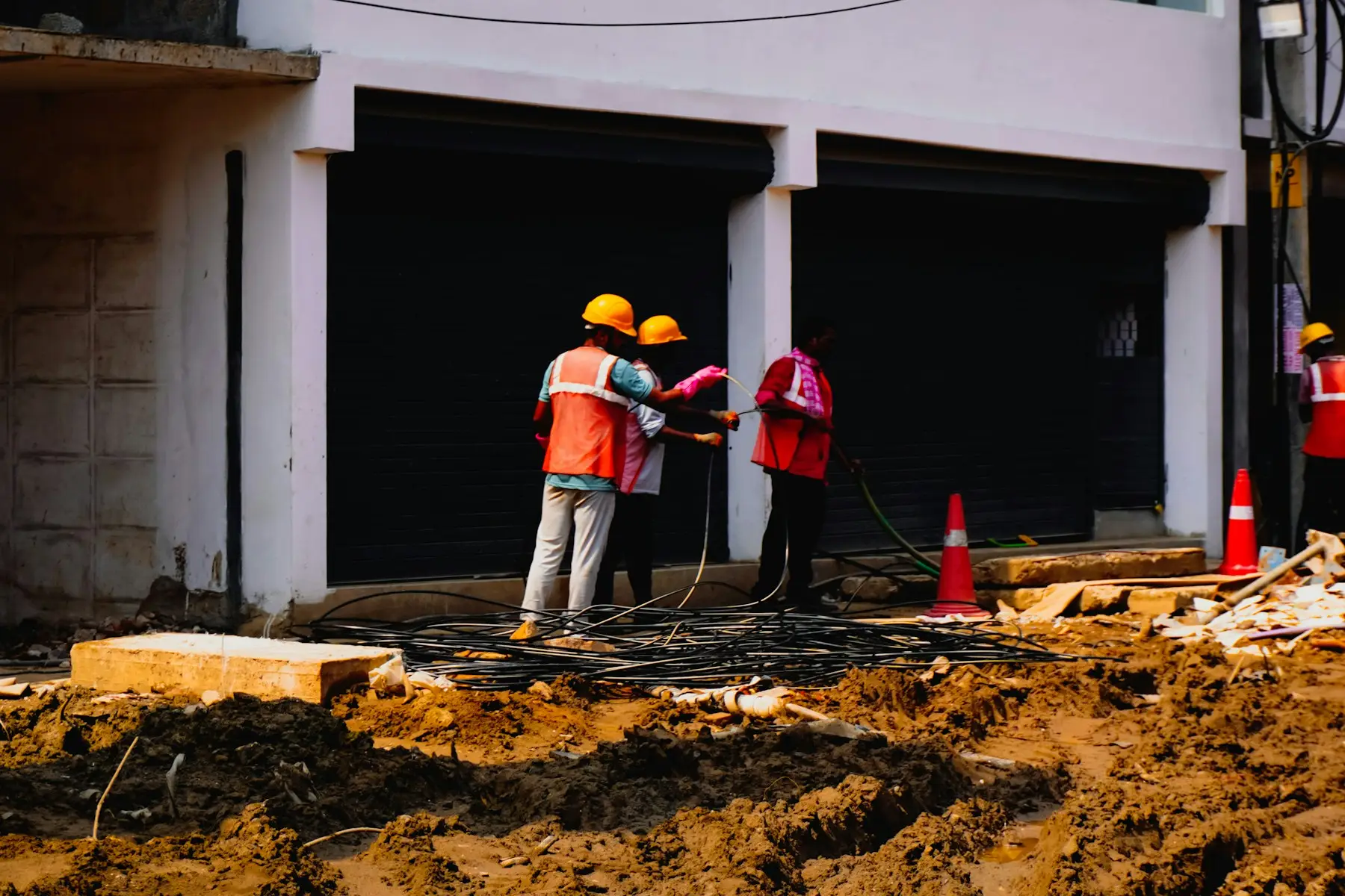 Construction workers wearing hard hats and high-visibility clothing on site
